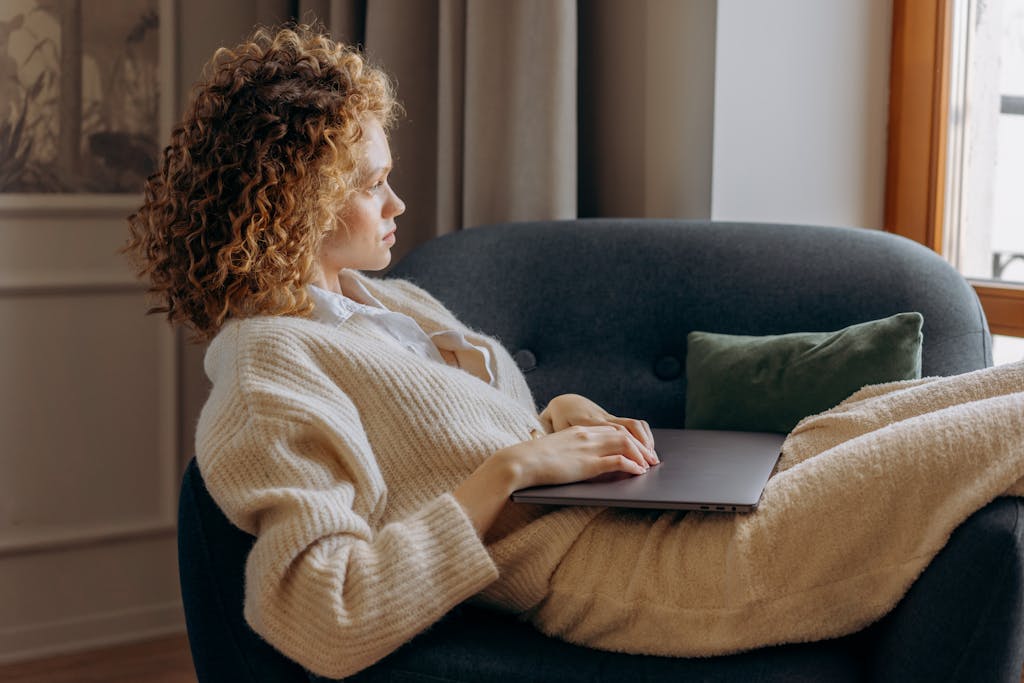 Woman Sitting on Sofa Chair